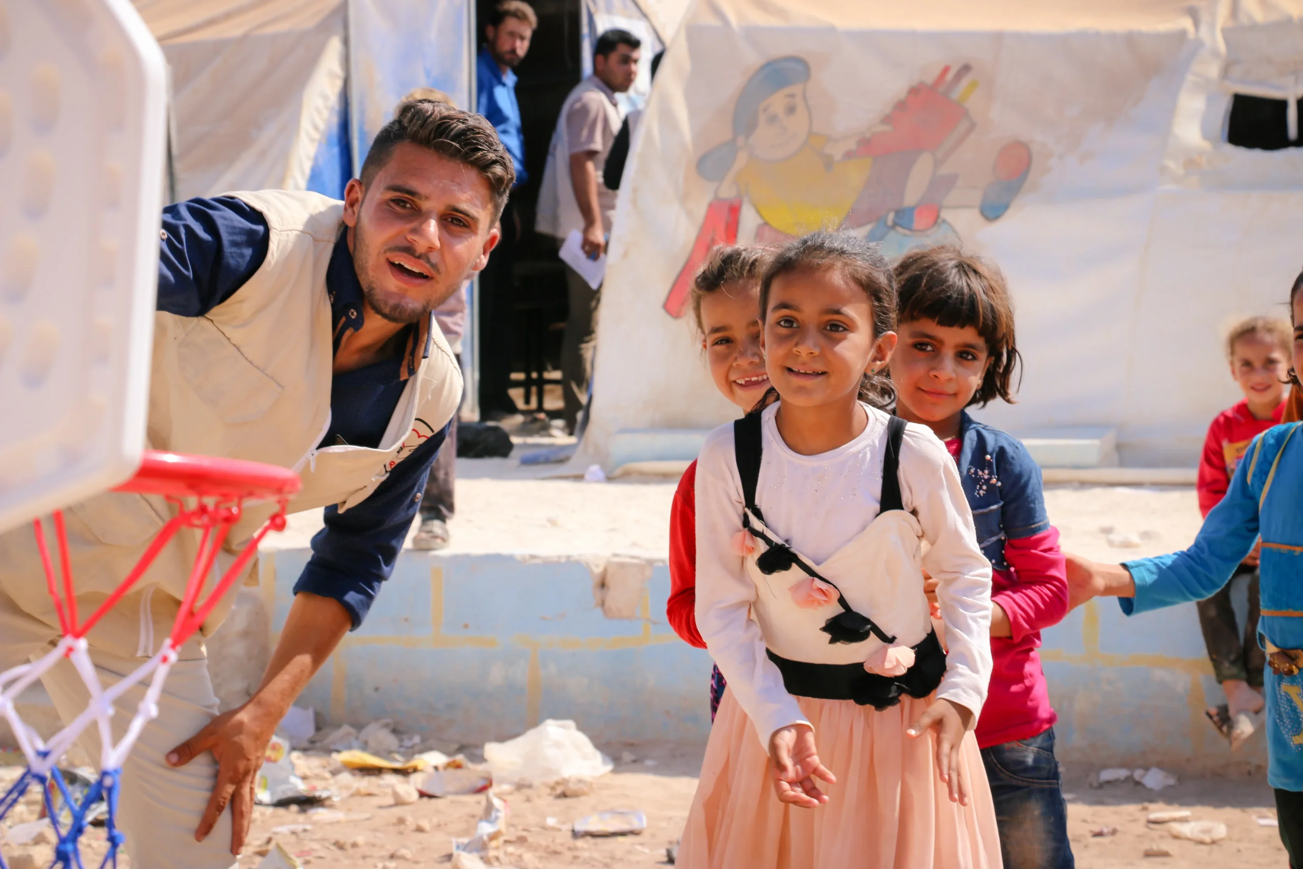 An aid worker with a young girl